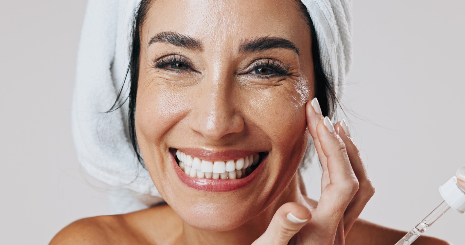 A smiling woman with radiant, healthy skin